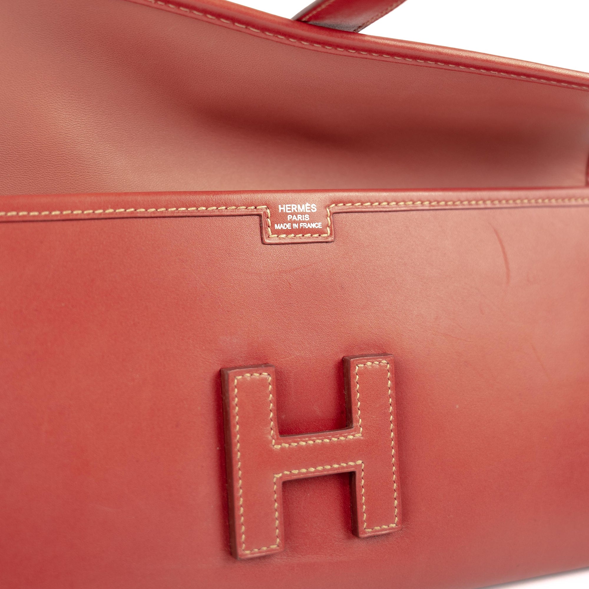 HERMES, Red leather clutch bag model JIGE, marked on the…